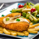 Frango à Cordon Bleu dourado servido com legumes